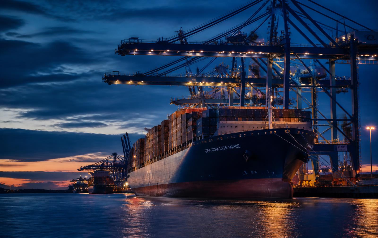 Container ship alongside a port terminal at dusk